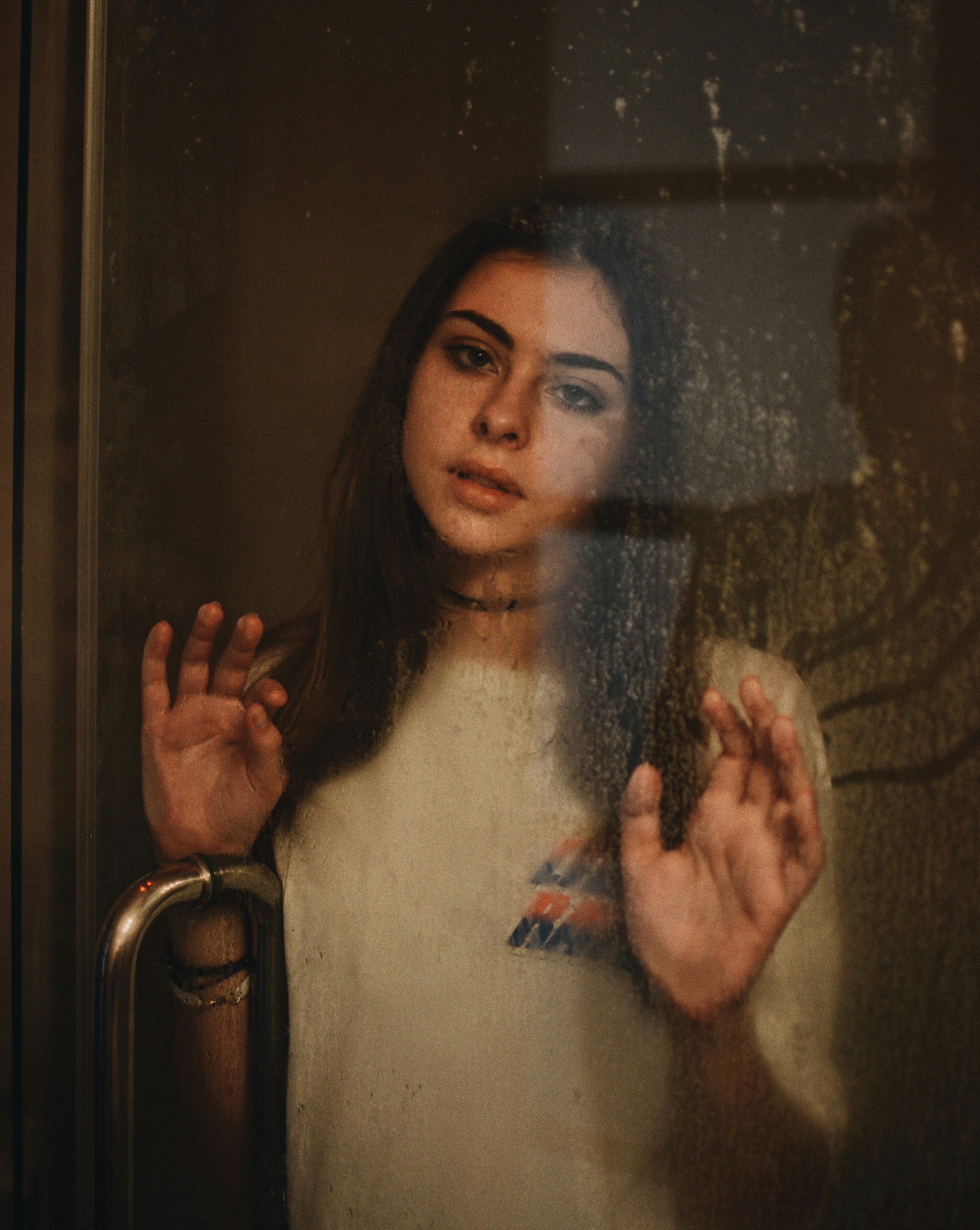woman leaning on glass door